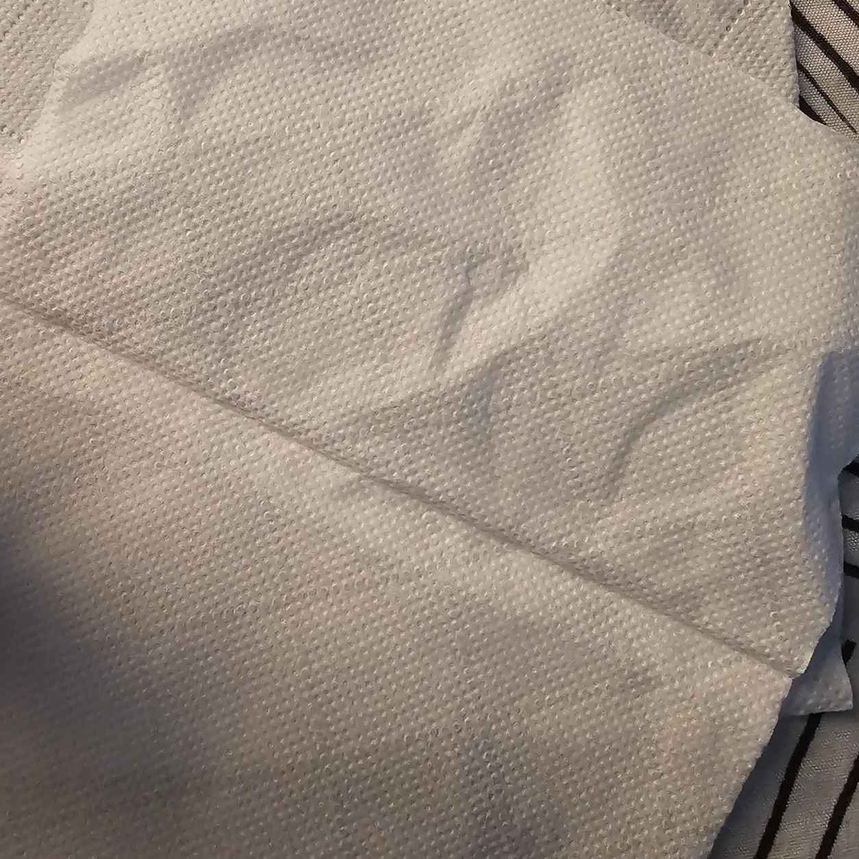 Facial tissue and toilet paper side by side, two paper products that look alike but behave very differently in water.